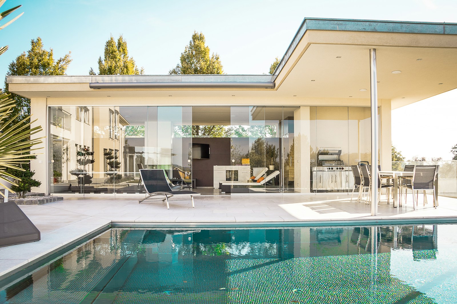 Contemporary home with floor-to-ceiling windows and a poolside terrace